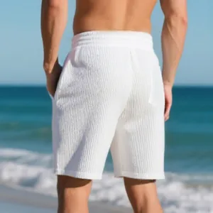 Back view of men's white jacquard beach shorts featuring vertical textured fabric detail.