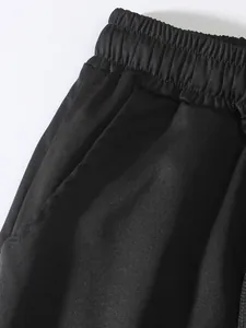 Vista dettagliata dei pantaloni cargo da uomo con vita elastica e tasca laterale.