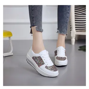 Women's stylish white platform rocker sneakers with colorful glitter sequins on foot