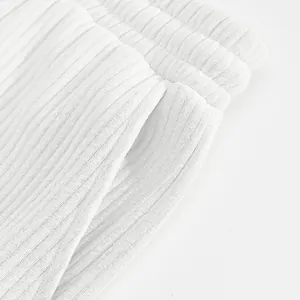 Macro view showing the heavy jacquard fabric texture of men's white casual beach shorts