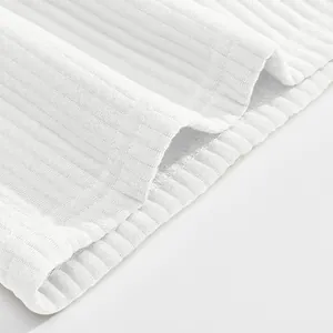 Detailed macro shot of white ribbed jacquard fabric with double stitching for men's shorts