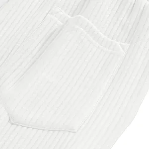 Detailed macro view of white ribbed knit fabric and pocket on men's casual beach shorts