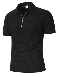 Detail of black polo shirt featuring a quarter-zip collar and geometric textured pattern.