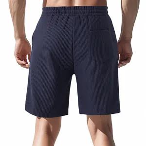 Rear view of men's navy blue shorts showing heavy jacquard texture and back pocket detail.