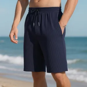 Detail of navy blue ribbed men's beach shorts with drawstring waist and textured fabric