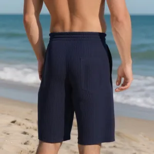 Back view of navy blue ribbed heavy jacquard beach shorts for men in outdoor setting