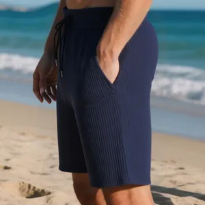 Detailed view of navy blue ribbed jacquard beach shorts for men with an adjustable drawstring.