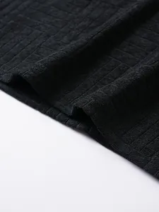 Detailed macro view of black waffle texture on a men's casual outdoor summer polo shirt
