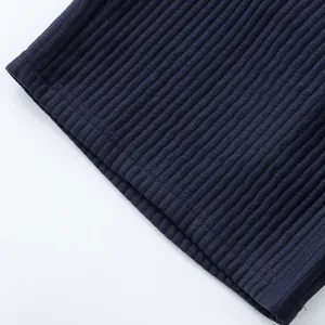 Close-up detail of navy blue ribbed jacquard fabric on men's casual shorts hem.