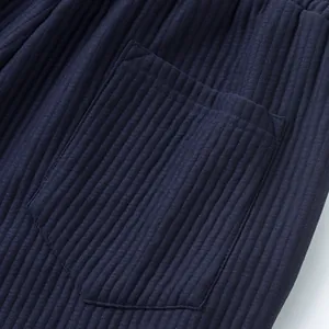 Close-up detail of navy blue ribbed jacquard fabric pocket on men's casual beach shorts