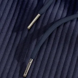 Close-up detail of navy blue jacquard fabric featuring premium metal-tipped drawstrings