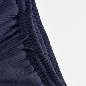 Close-up of textured ribbed fabric and elastic waistband on men's navy shorts