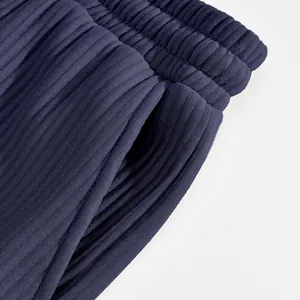 Close-up detail of navy blue heavy jacquard shorts showing waistband and pocket texture.
