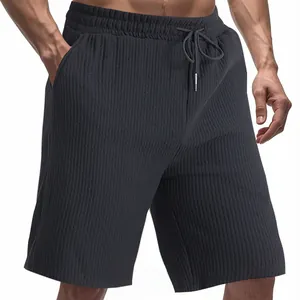 Close-up detail of men's dark grey jacquard textured casual shorts with drawstring waist