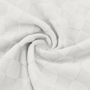 Close-up of white heavyweight checkerboard jacquard fabric texture on men's polo shirt