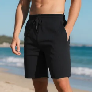 Close-up detail of black men's summer beach shorts with premium vertical ribbed texture.