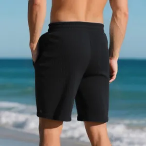 Detailed back view of men's black heavy jacquard beach shorts with ribbed texture