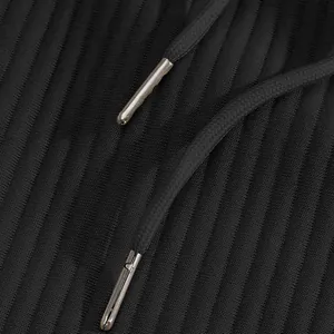 Macro view of textured black jacquard fabric with premium metal aglet drawstrings