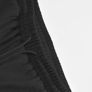 Close-up of black men's shorts with ribbed texture and elastic drawstring waistband