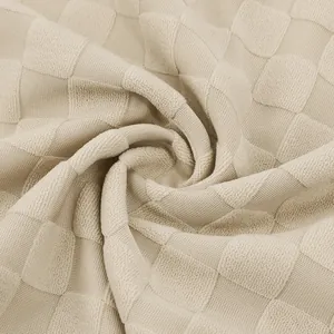 Close-up of heavyweight cream checkerboard jacquard fabric texture for men's polo shirt