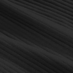 Macro view showing the detailed texture of black heavyweight ribbed jacquard fabric for shorts