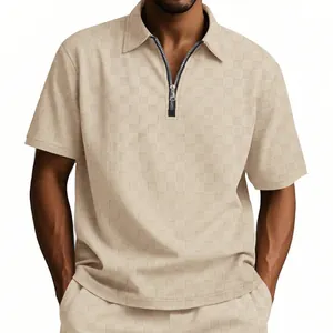 Detail of men's polo shirt featuring heavy checkered jacquard texture and half-zip collar