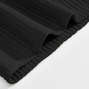 Detail shot of heavy jacquard ribbed fabric on men's black sports shorts