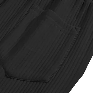 Close-up view of the ribbed texture and pocket detail on black men's casual shorts