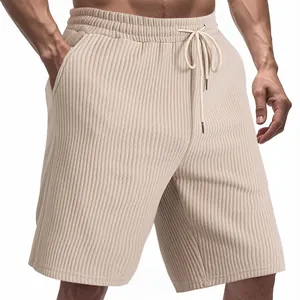 Detailed close-up of beige textured jacquard men's athletic shorts with drawstring waist