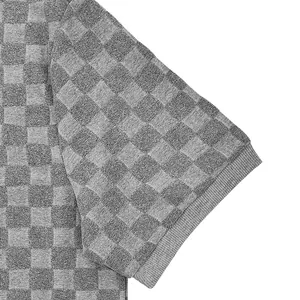 Close-up of grey checkerboard jacquard fabric on a men's short sleeve polo shirt