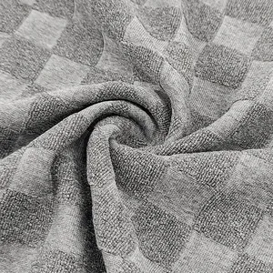 Macro view of gray checkerboard jacquard fabric for men's heavyweight polo shirt