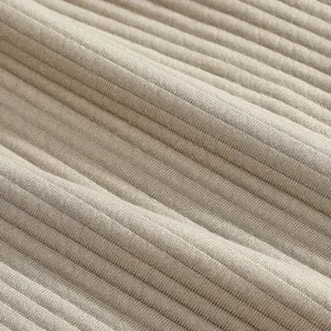Macro view of the ribbed jacquard fabric texture of beige men's casual beach shorts