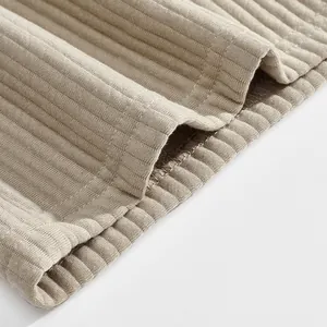 Close-up of heavy luxury jacquard fabric texture and stitching on men's beach shorts