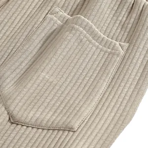Macro view of textured jacquard fabric and pocket detail on men's summer beach shorts.