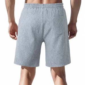 Back view of grey men's shorts showing vertical ribbed jacquard texture and patch pocket