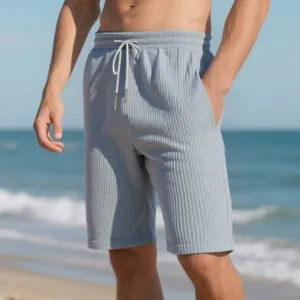Detailed view of men's grey jacquard beach shorts with adjustable drawstring waist.