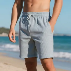 Detail of men's summer textured waffle knit casual beach shorts on a beach model