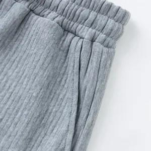 Close-up detail of grey heavy jacquard fabric and elastic waistband on men's shorts