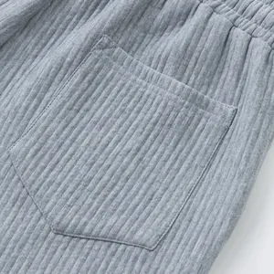 Close-up detail of grey mens heavy jacquard shorts showing pocket and ribbed texture