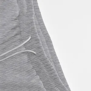 Close-up of the heavyweight jacquard fabric texture and drawstring on grey sports shorts