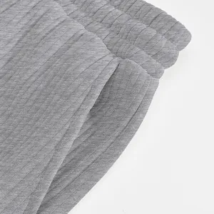 High-quality close-up detail of gray textured jacquard fabric on men's casual sports shorts