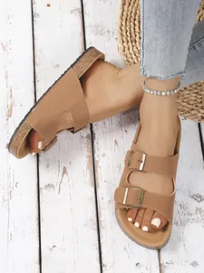 Detail shot of women's stylish tan double buckle platform sandals with cork soles