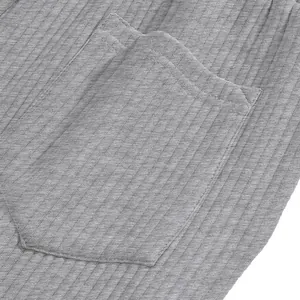Close-up of grey jacquard ribbed fabric and pocket detail on men's beach shorts