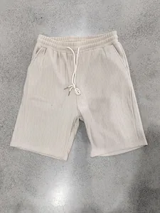 Close-up detail of men's beige ribbed heavy jacquard casual drawstring beach shorts
