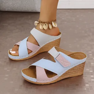 Side view of women's color-block wedge sandals with Velcro straps and wood-textured heel detail.