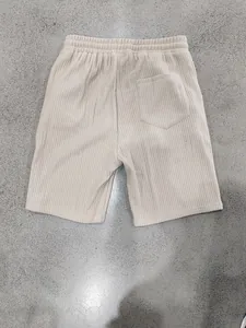 Macro view of the high-quality beige ribbed fabric on men's casual beach shorts