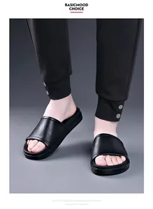 Close-up of men's black casual slippers with textured upper and thick EVA sole