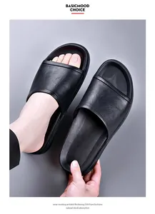 Detailed view of black men's slippers featuring premium textured upper and thick EVA sole