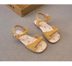 Detail view of yellow toddler girls' sandals with sweet floral print and bow detail