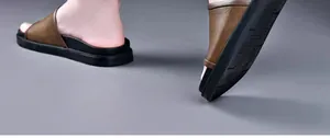 Close-up of men's brown leather texture sandals with non-slip black sole